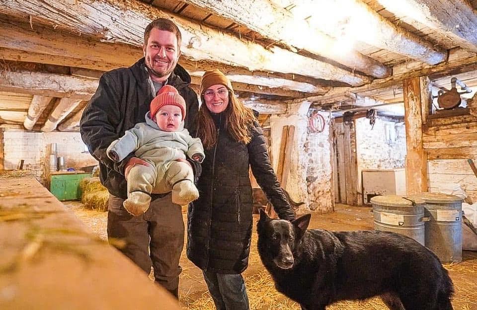 Samantha Turner and her family in the barn with their dog